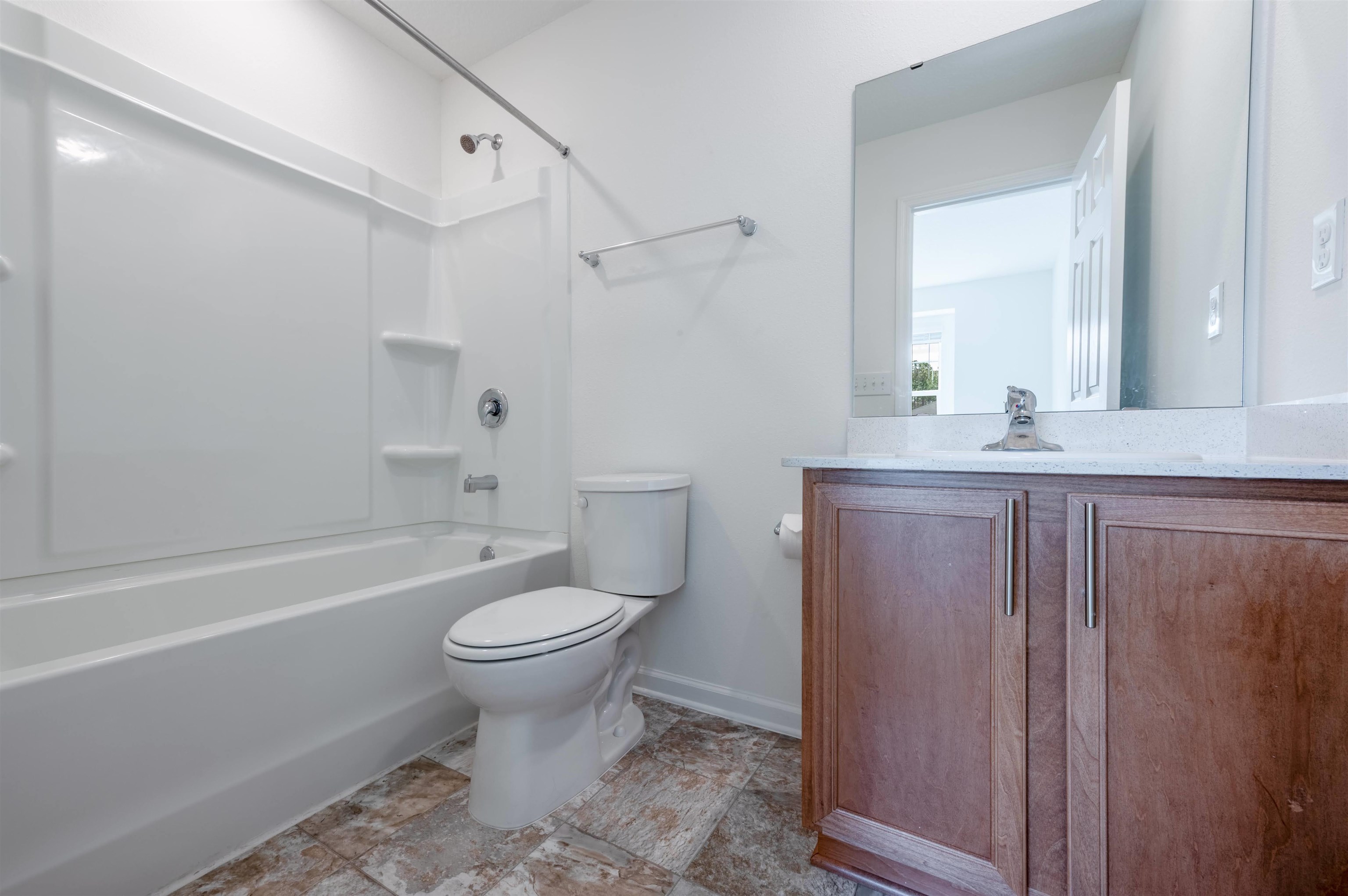 48 Mustard Hill St. Augustine, FL 32086 - Photo 20 of 28 a bathroom with a granite countertop toilet a sink and a bathtub