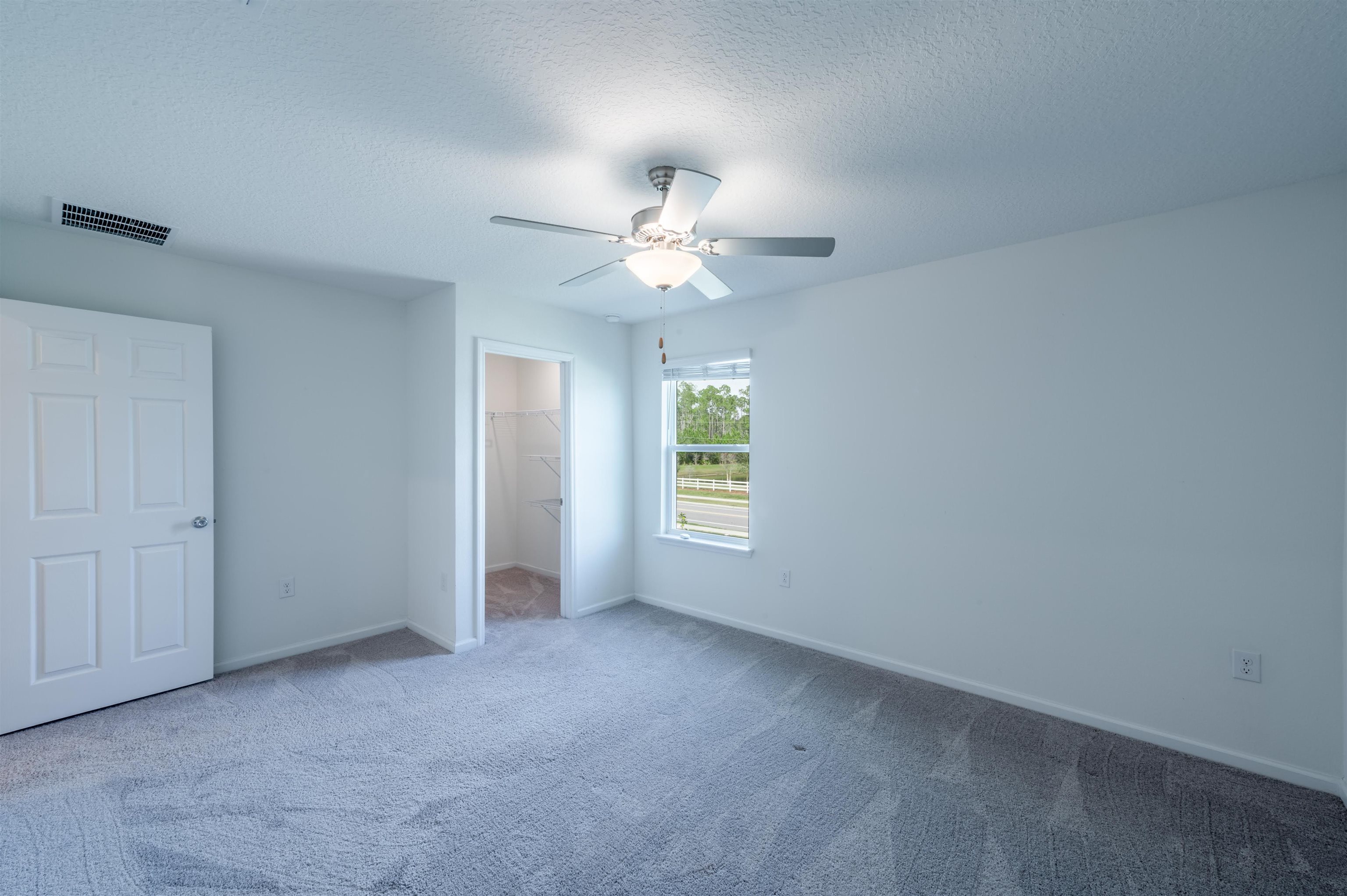 48 Mustard Hill St. Augustine, FL 32086 - Photo 24 of 28 an empty room with a window and a ceiling fan