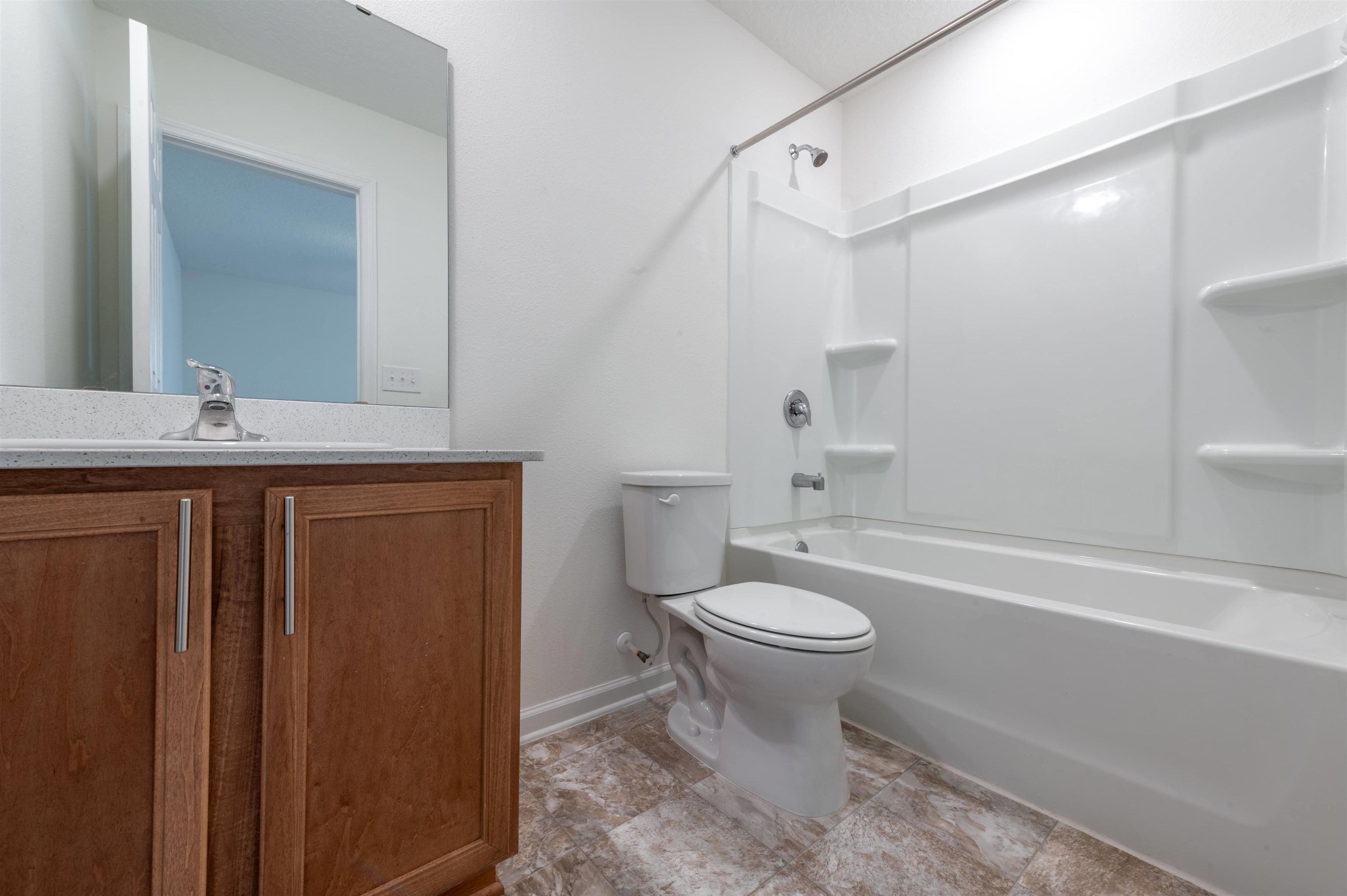 48 Mustard Hill St. Augustine, FL 32086 - Photo 27 of 28 a bathroom with a granite countertop toilet a sink and a bathtub