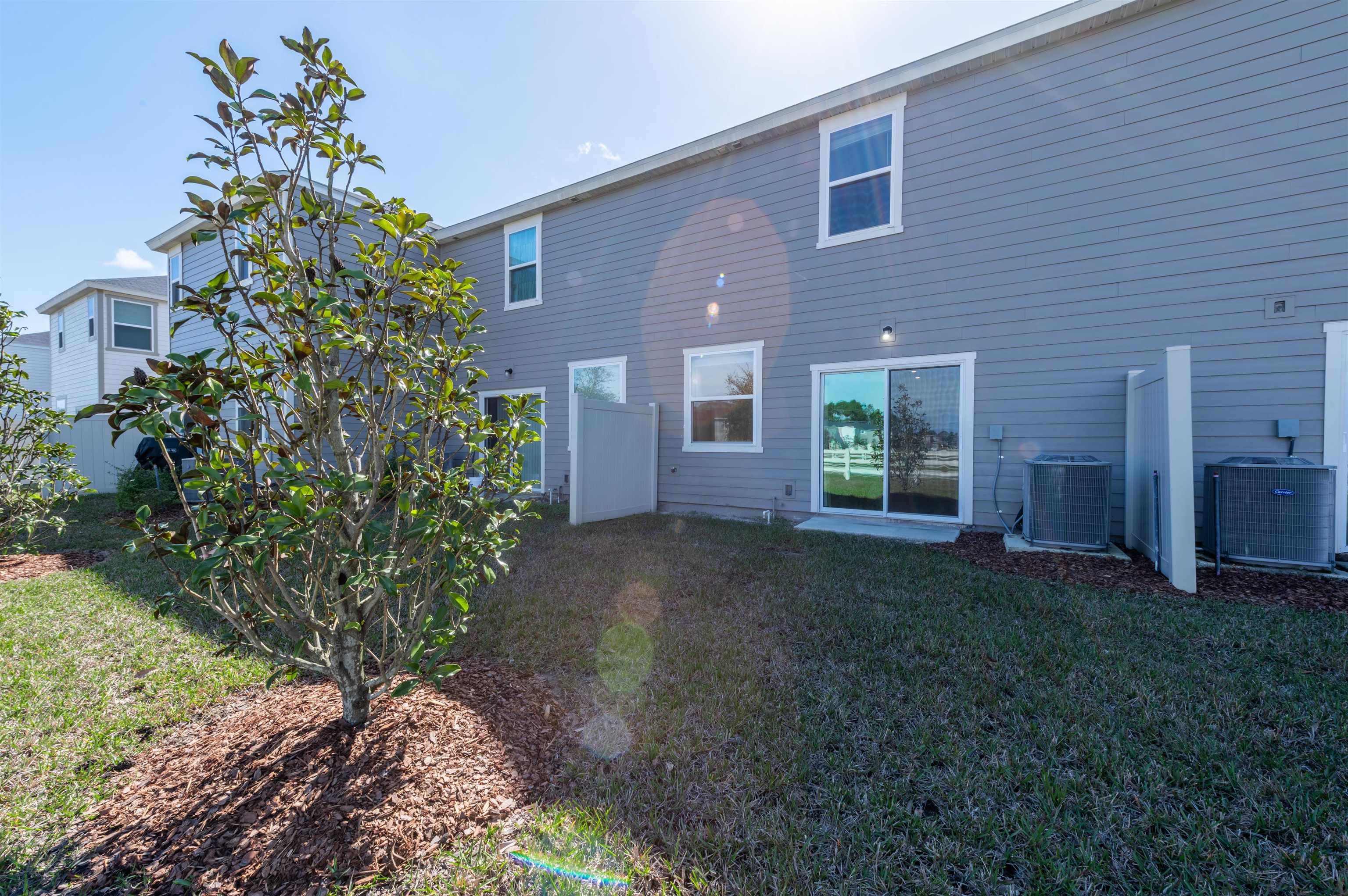 48 Mustard Hill St. Augustine, FL 32086 - Photo 4 of 28 a view of a brick house with a yard and plants