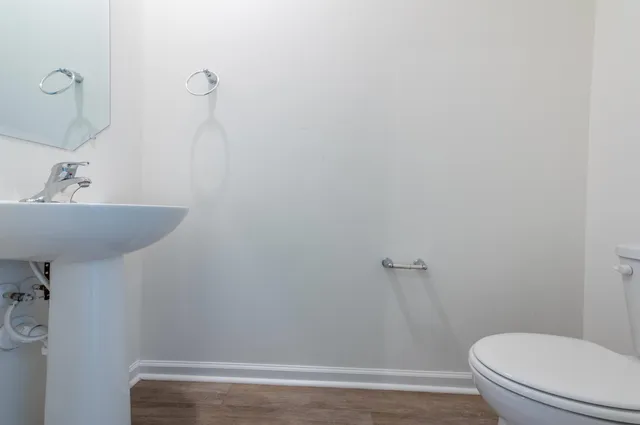 a bathroom with a sink a toilet and a mirror