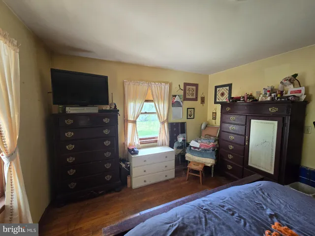 a bedroom with a bed and a television in it