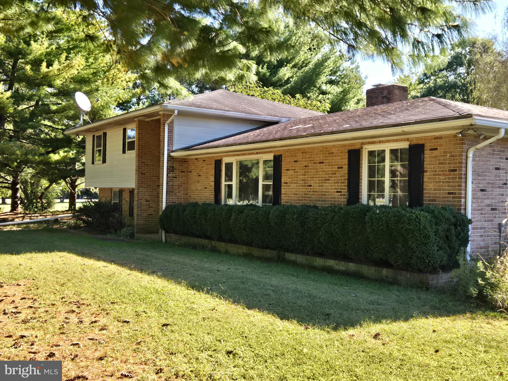 938 Church Hill Road Milford, DE 19963 - Photo 5 of 41 Charming brick home with lush greenery.