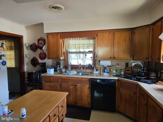 a kitchen with a sink cabinets and window