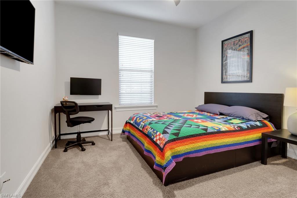 14374 Tuscany Pointe Trail Naples, FL 34120 - Photo 17 of 38 a bedroom with a bed and a flat screen tv