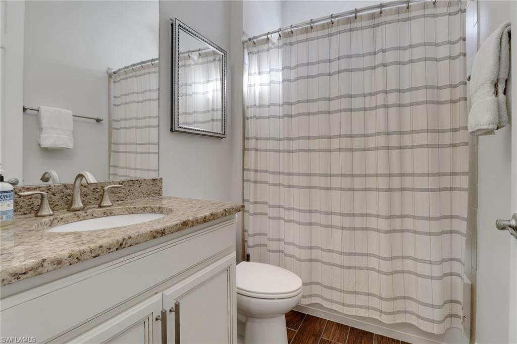 14374 Tuscany Pointe Trail Naples, FL 34120 - Photo 19 of 38 a bathroom with a granite countertop sink toilet and shower
