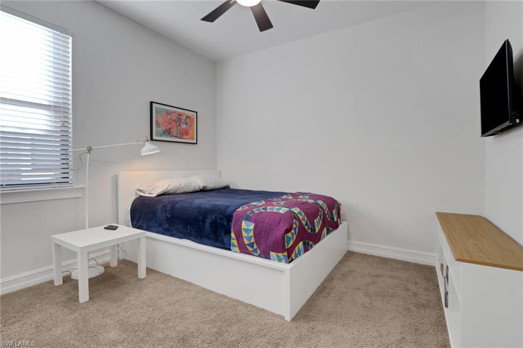 14374 Tuscany Pointe Trail Naples, FL 34120 - Photo 20 of 38 a spacious bedroom with a bed and a flat screen tv