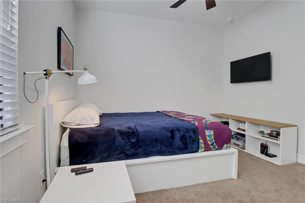 14374 Tuscany Pointe Trail Naples, FL 34120 - Photo 21 of 38 a living room with furniture and a flat screen tv