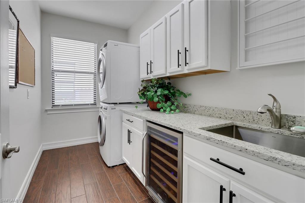 14374 Tuscany Pointe Trail Naples, FL 34120 - Photo 22 of 38 a kitchen with a sink and cabinets
