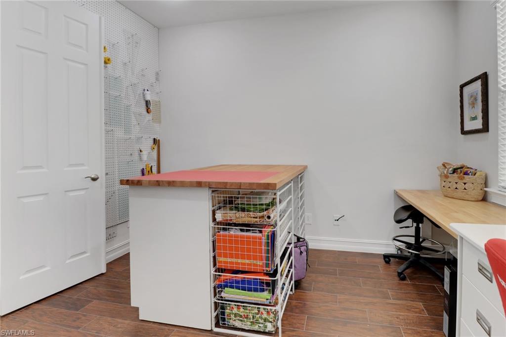 14374 Tuscany Pointe Trail Naples, FL 34120 - Photo 24 of 38 a room with a desk and a workspace