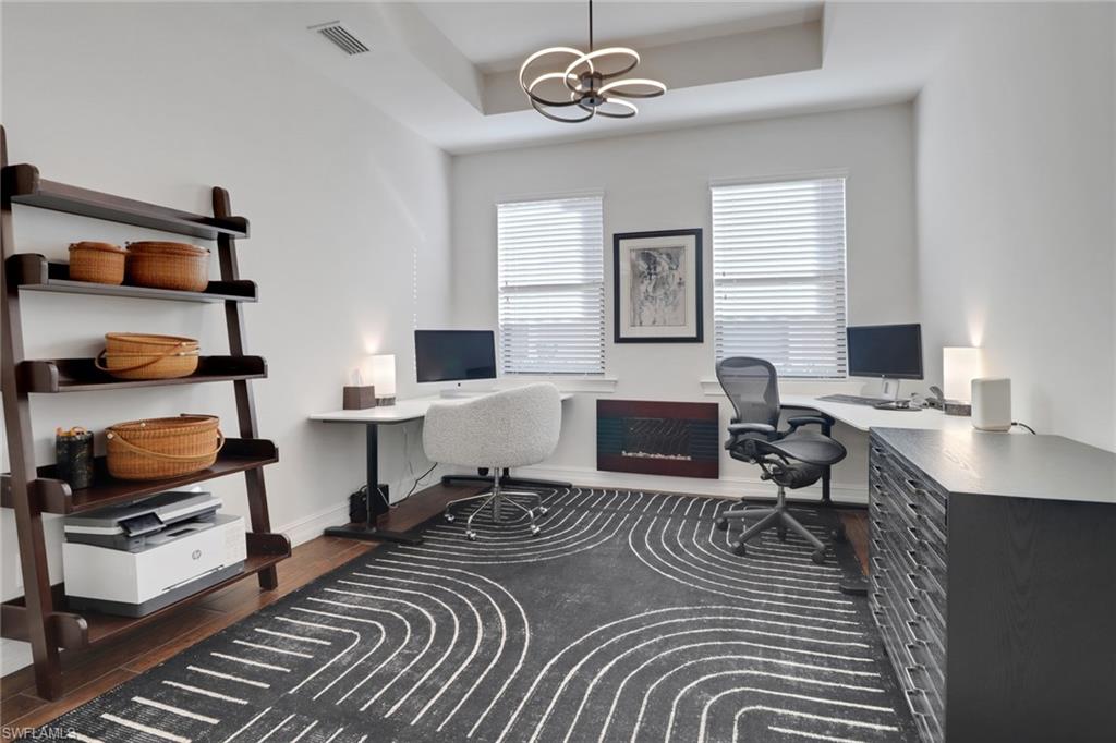 14374 Tuscany Pointe Trail Naples, FL 34120 - Photo 26 of 38 a living room with furniture and a wooden floor