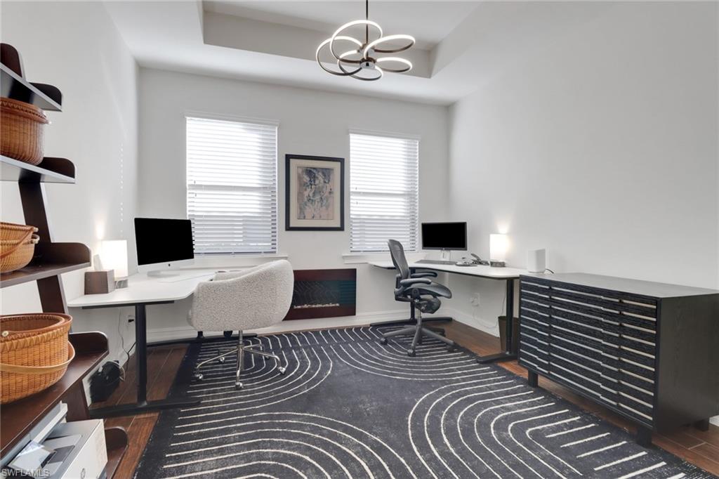 14374 Tuscany Pointe Trail Naples, FL 34120 - Photo 27 of 38 a living room with furniture a window and a flat screen tv