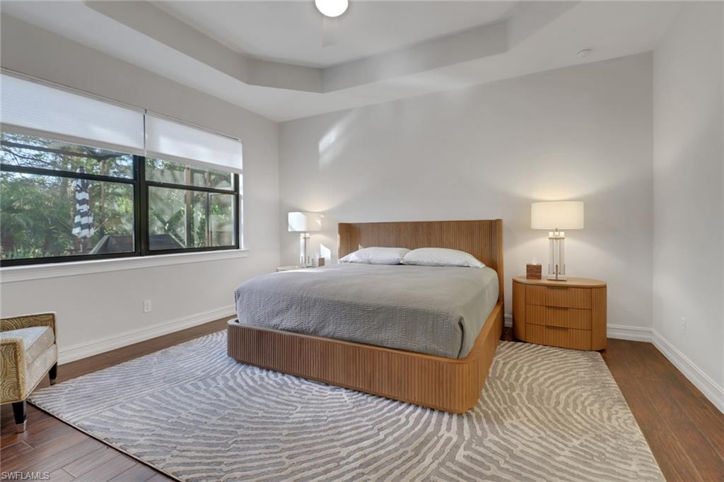 14374 Tuscany Pointe Trail Naples, FL 34120 - Photo 28 of 38 a bedroom with a large bed and a large window