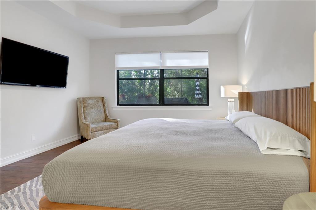 14374 Tuscany Pointe Trail Naples, FL 34120 - Photo 29 of 38 a bedroom with a bed tv and window