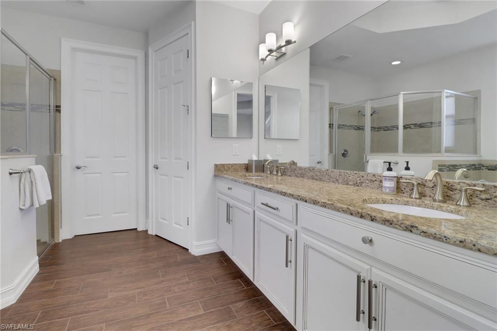 14374 Tuscany Pointe Trail Naples, FL 34120 - Photo 31 of 38 a bathroom with a granite countertop sink and a mirror