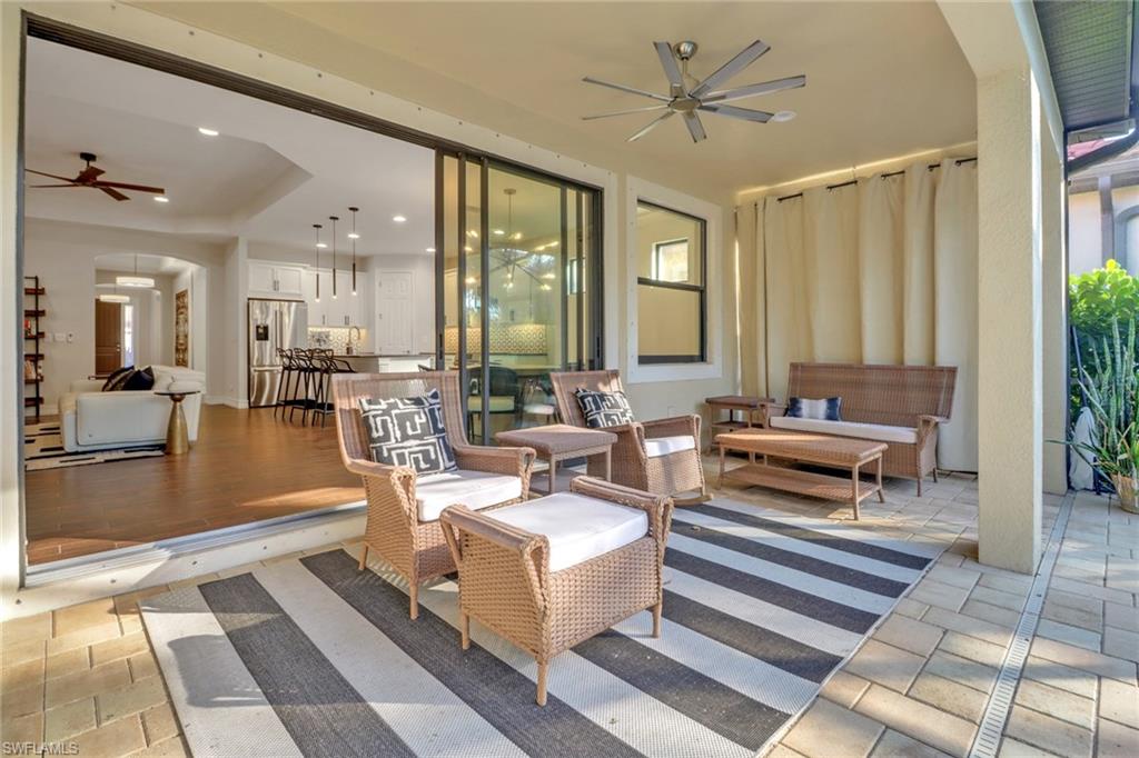 14374 Tuscany Pointe Trail Naples, FL 34120 - Photo 34 of 38 a living room with furniture and a large window