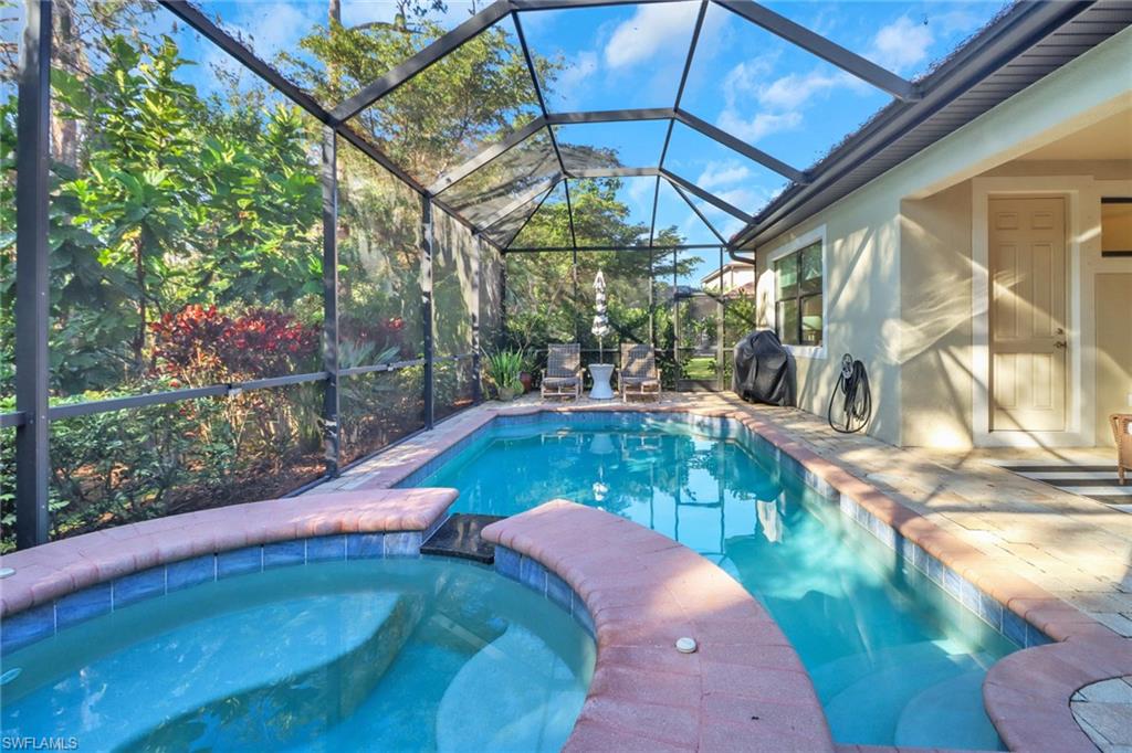 14374 Tuscany Pointe Trail Naples, FL 34120 - Photo 36 of 38 a view of a swimming pool with a patio