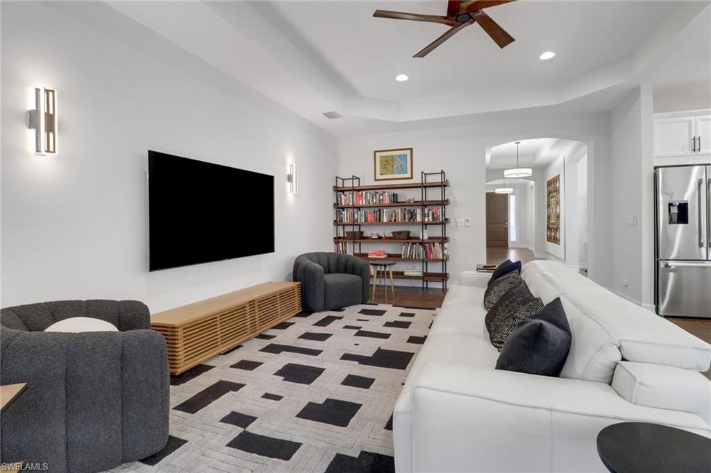 14374 Tuscany Pointe Trail Naples, FL 34120 - Photo 7 of 38 a living room with furniture and a flat screen tv