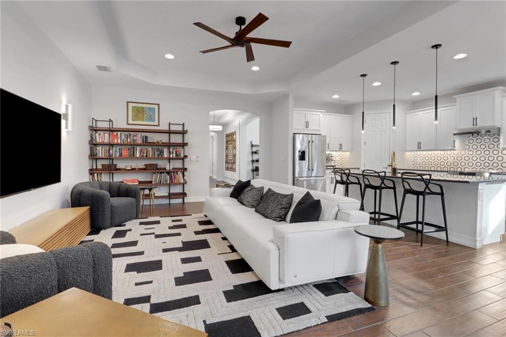 14374 Tuscany Pointe Trail Naples, FL 34120 - Photo 8 of 38 a living room with furniture and kitchen view