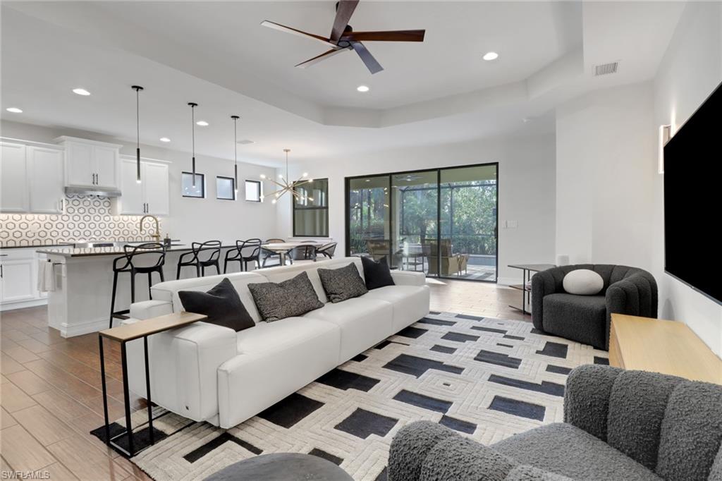 14374 Tuscany Pointe Trail Naples, FL 34120 - Photo 10 of 38 a living room with furniture and a large window