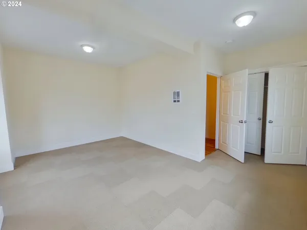 an empty room with closet area