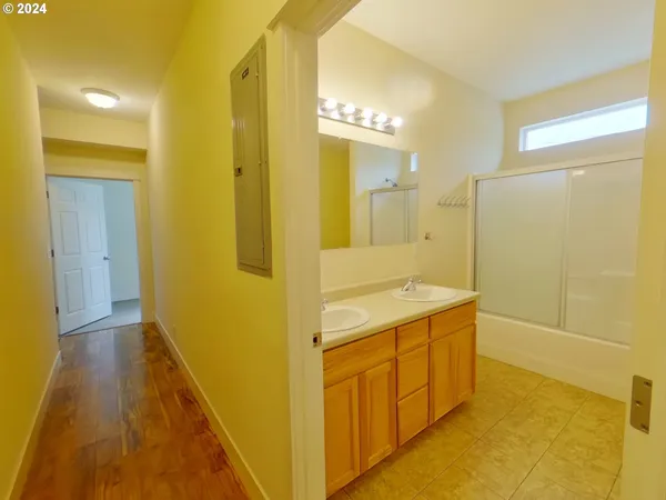 a bathroom with a double vanity sink and a mirror