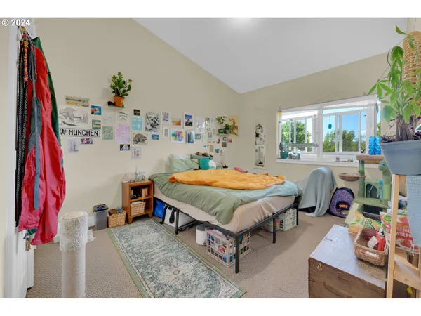 a bedroom with a bed a dresser and a large mirror