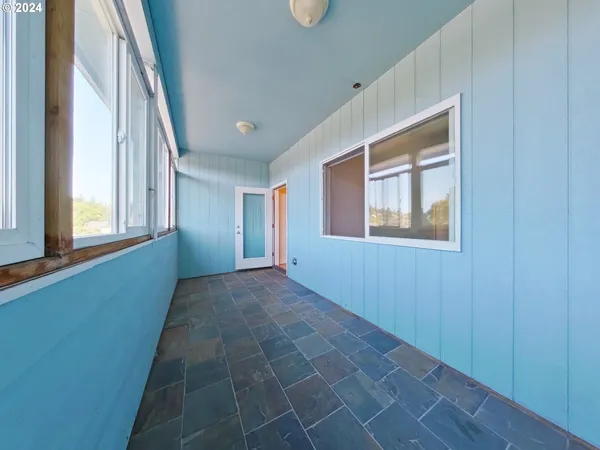 a view of an empty room with windows