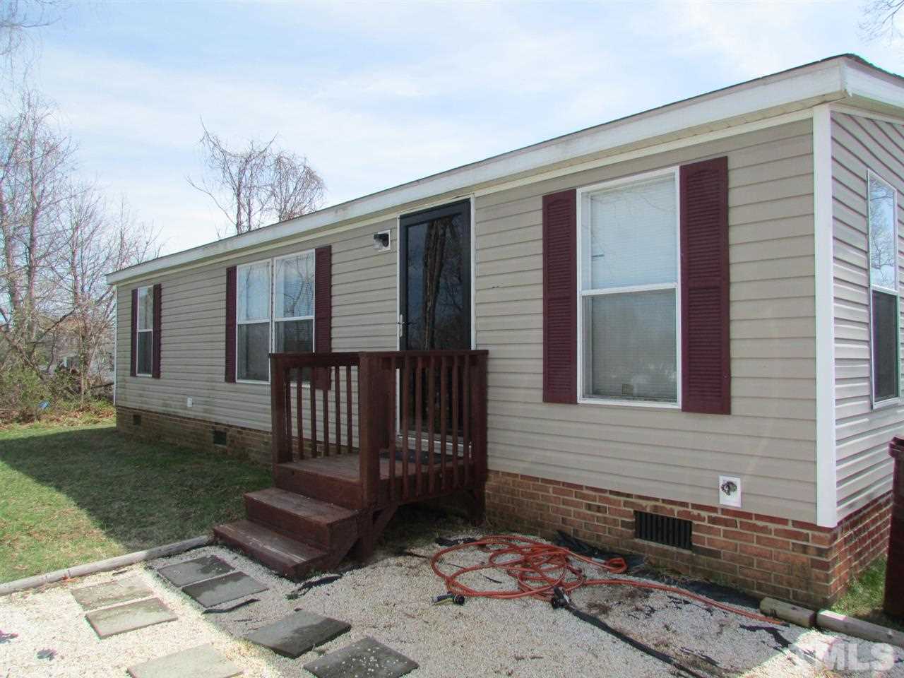 1294 Allensville Road Roxboro, NC 27574 - Photo 1 of 16 a front view of a house with garden