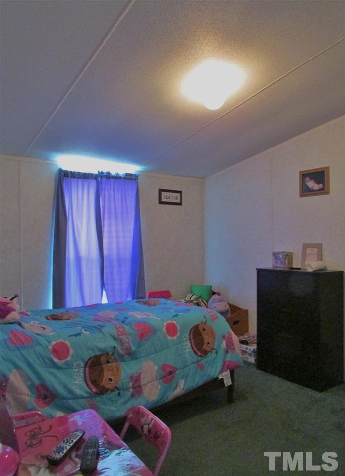 1294 Allensville Road Roxboro, NC 27574 - Photo 11 of 16 a bedroom with a bed and a dresser