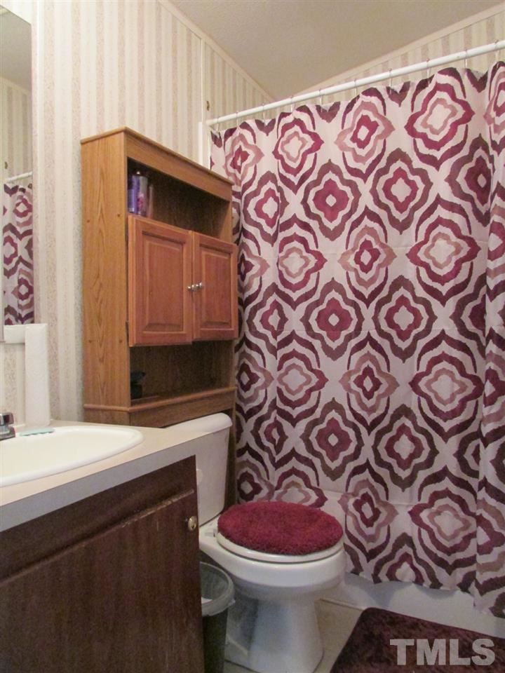 1294 Allensville Road Roxboro, NC 27574 - Photo 12 of 16 a bathroom with a sink and a toilet