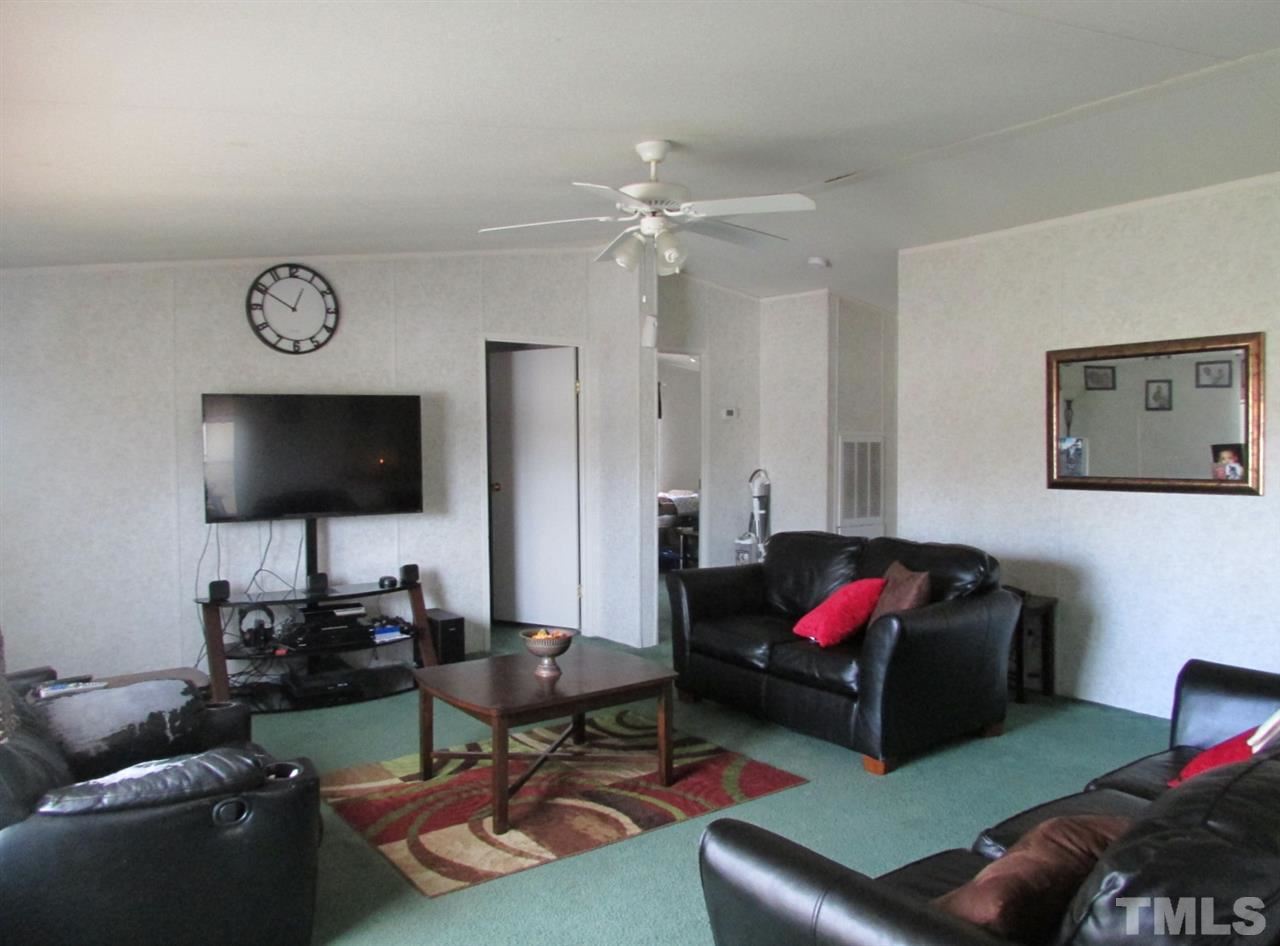 1294 Allensville Road Roxboro, NC 27574 - Photo 3 of 16 a living room with furniture and a flat screen tv