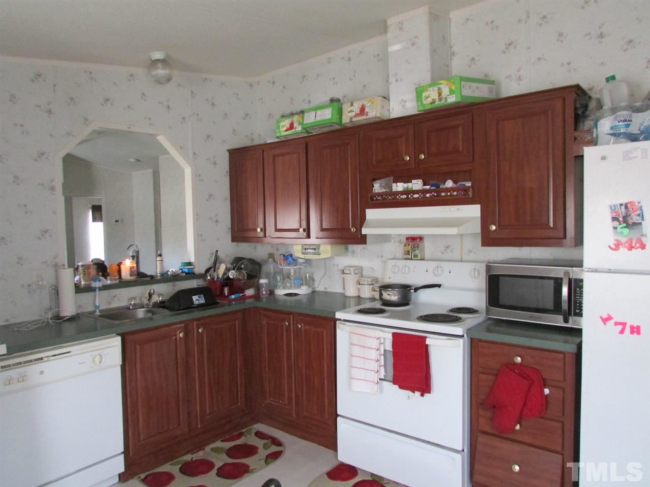1294 Allensville Road Roxboro, NC 27574 - Photo 6 of 16 a kitchen with granite countertop a sink stove and cabinets