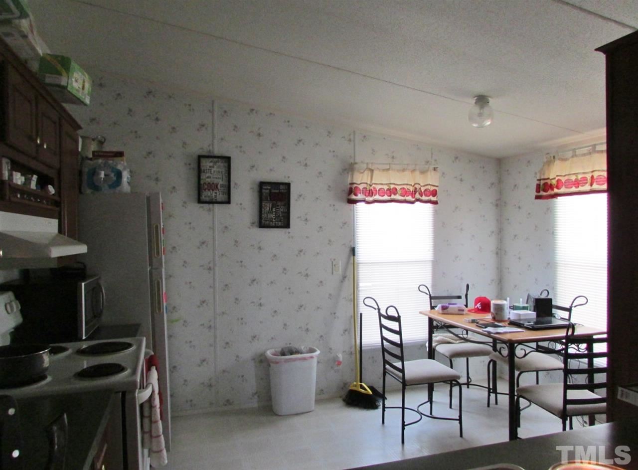 1294 Allensville Road Roxboro, NC 27574 - Photo 7 of 16 a workspace with furniture and a fireplace
