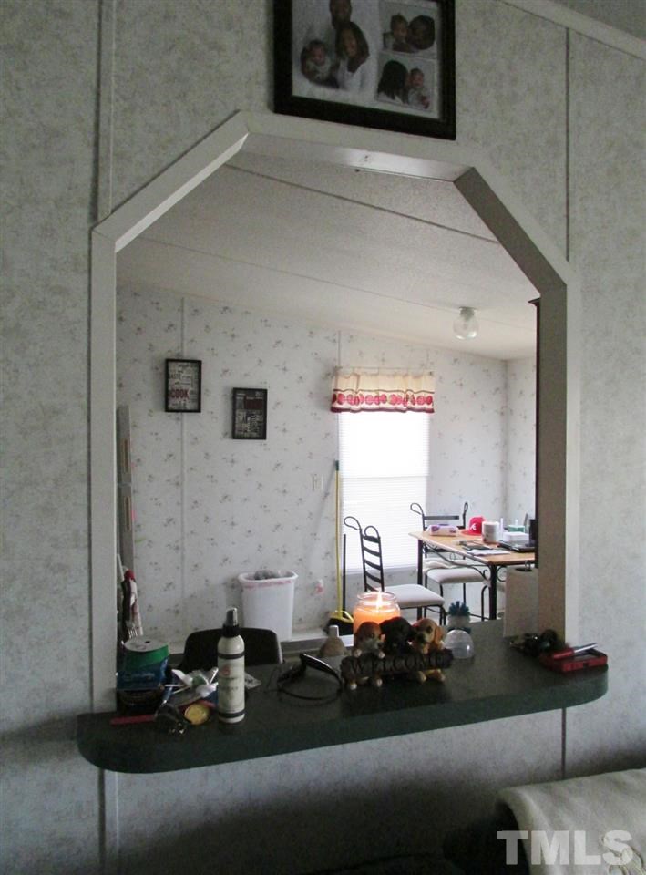 1294 Allensville Road Roxboro, NC 27574 - Photo 8 of 16 a living room with furniture and a fireplace