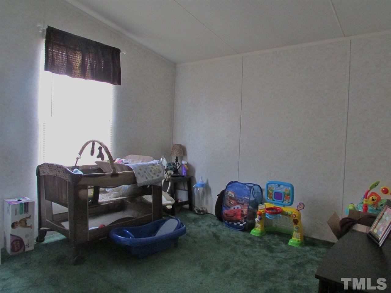 1294 Allensville Road Roxboro, NC 27574 - Photo 10 of 16 a room with toys and a wooden floor
