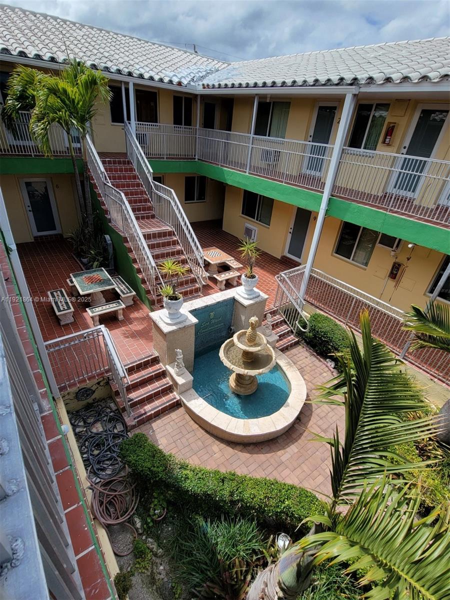7400 Harding Avenue, Unit 15 Miami Beach, FL 33141 - Photo 28 of 29 a backyard of a house with outdoor seating