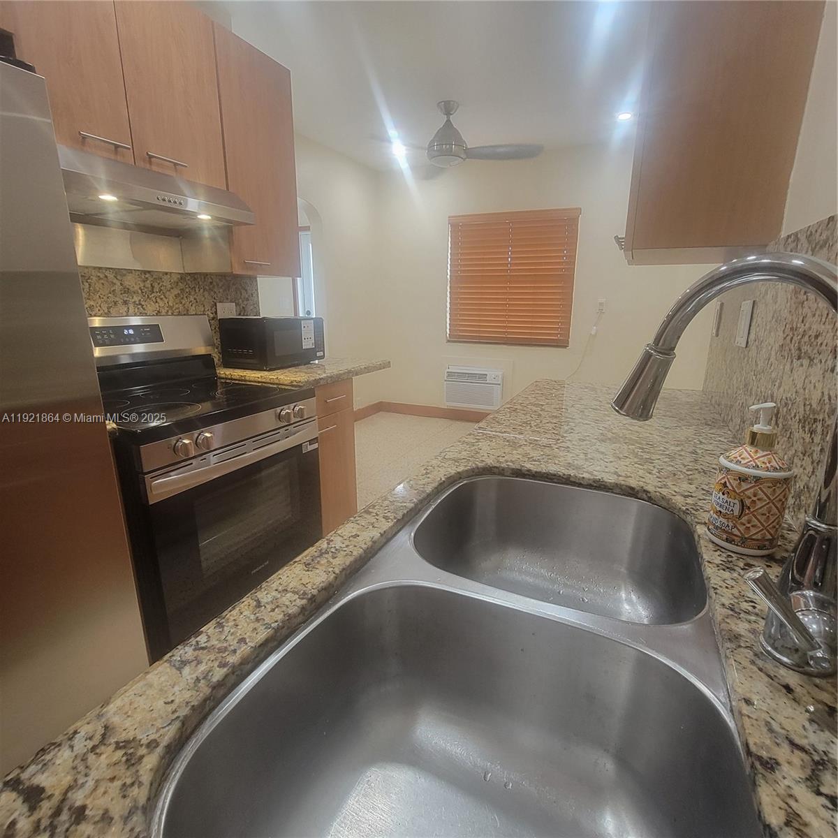 7400 Harding Avenue, Unit 15 Miami Beach, FL 33141 - Photo 7 of 29 a kitchen with a sink and a stove top oven