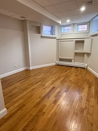 a view of a room with wooden floor and electronic appliances