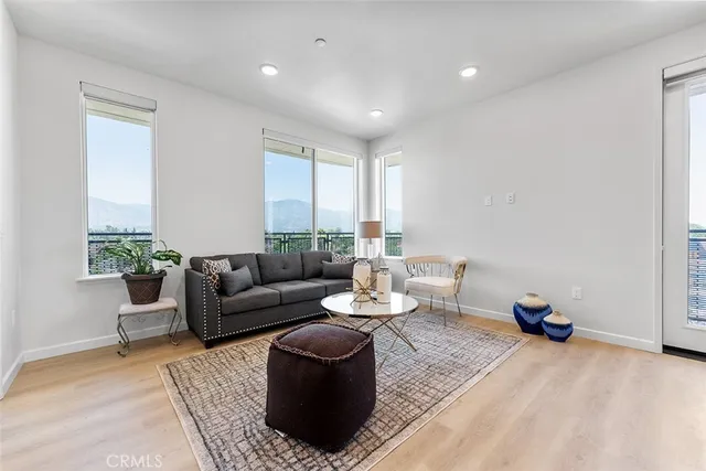 a living room with furniture and a potted plant