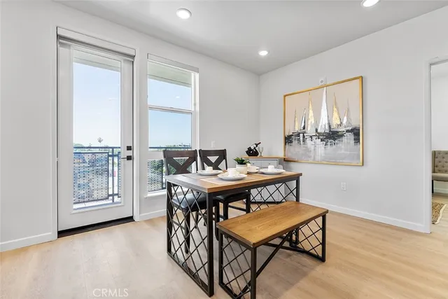 a dining room with furniture and wooden floor