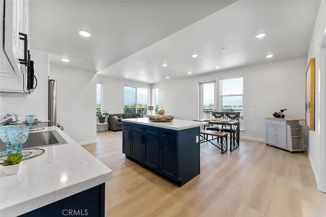 a living room with furniture a wooden floor and a sink