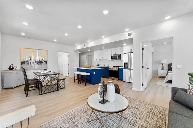 a living room with furniture and kitchen view