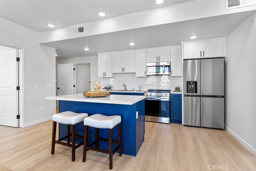 4064 Live Oak Avenue, Unit 208 Arcadia, CA 91006 - Photo 28 of 50 a kitchen with stainless steel appliances granite countertop a refrigerator a sink dishwasher a stove and white countertops with wooden floor