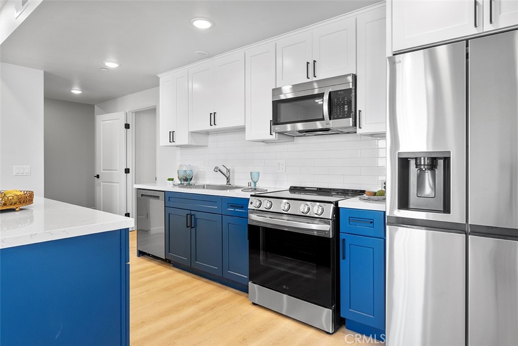 4064 Live Oak Avenue, Unit 208 Arcadia, CA 91006 - Photo 3 of 50 a kitchen with stainless steel appliances granite countertop a stove top oven microwave and cabinets