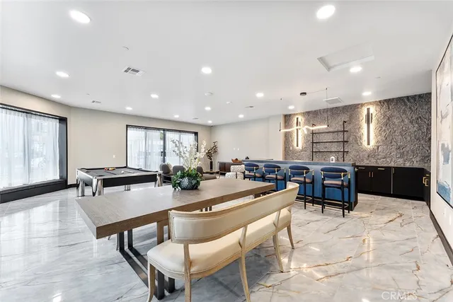a kitchen with a table chairs stove and kitchen view