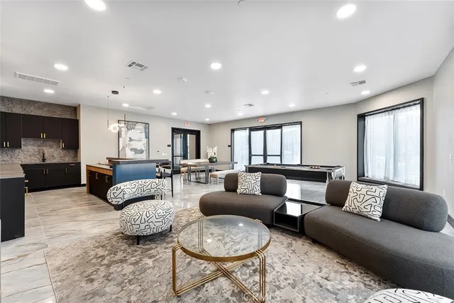 a living room with furniture and a large window