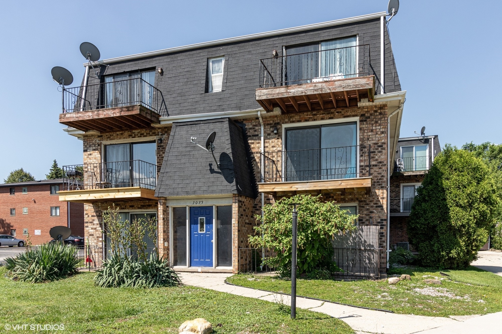 7033 Mather Avenue, Unit 2A Chicago Ridge, IL 60415 - Photo 1 of 10 a front view of a house with garden