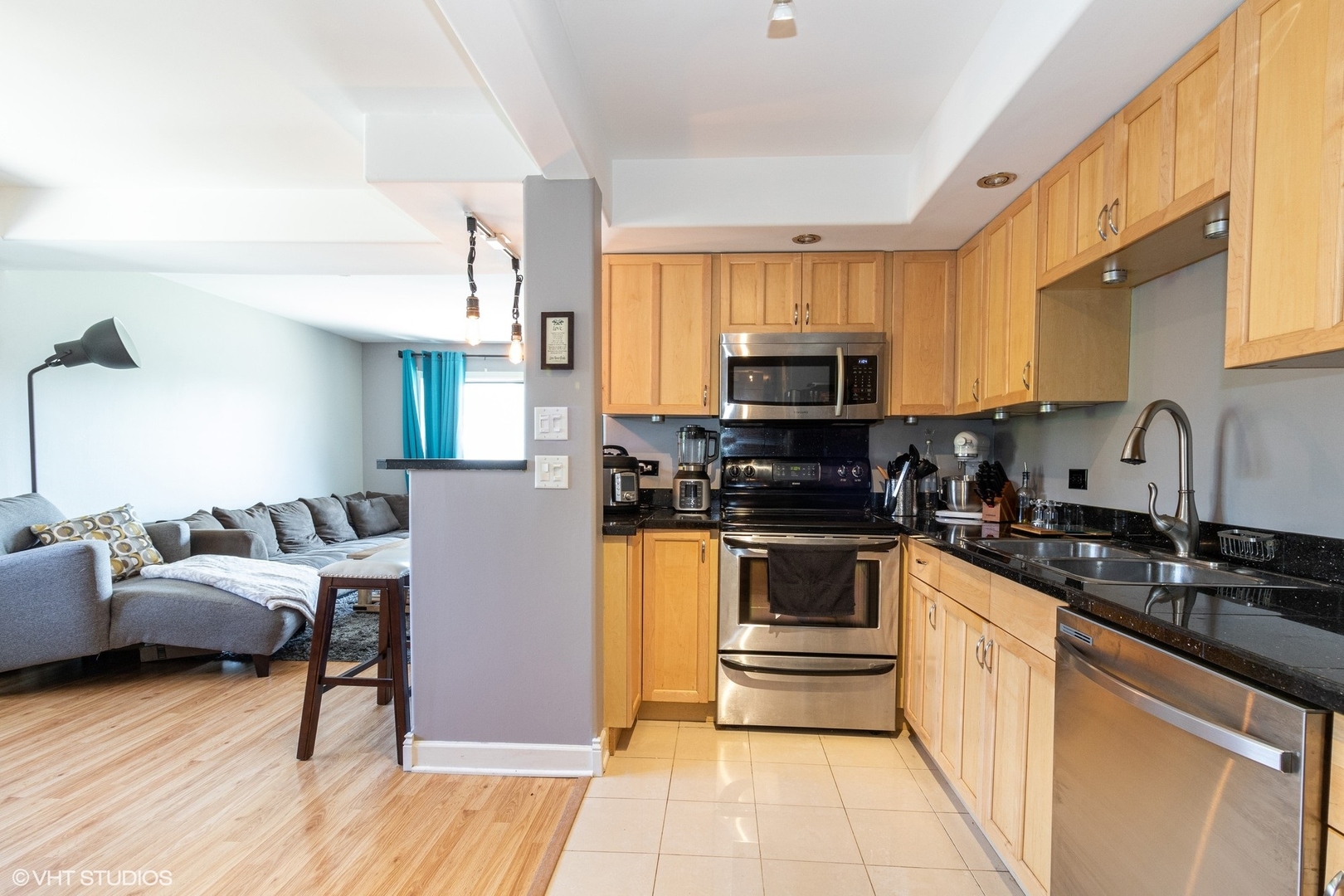 7033 Mather Avenue, Unit 2A Chicago Ridge, IL 60415 - Photo 4 of 10 a kitchen with stainless steel appliances a stove a sink cabinets and a wooden floor
