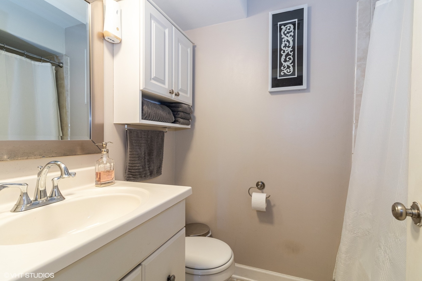 7033 Mather Avenue, Unit 2A Chicago Ridge, IL 60415 - Photo 8 of 10 a bathroom with a sink mirror vanity and toilet